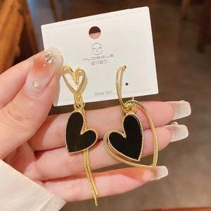 ASYMMETRICAL BLACK & GOLD HEART EARRINGS